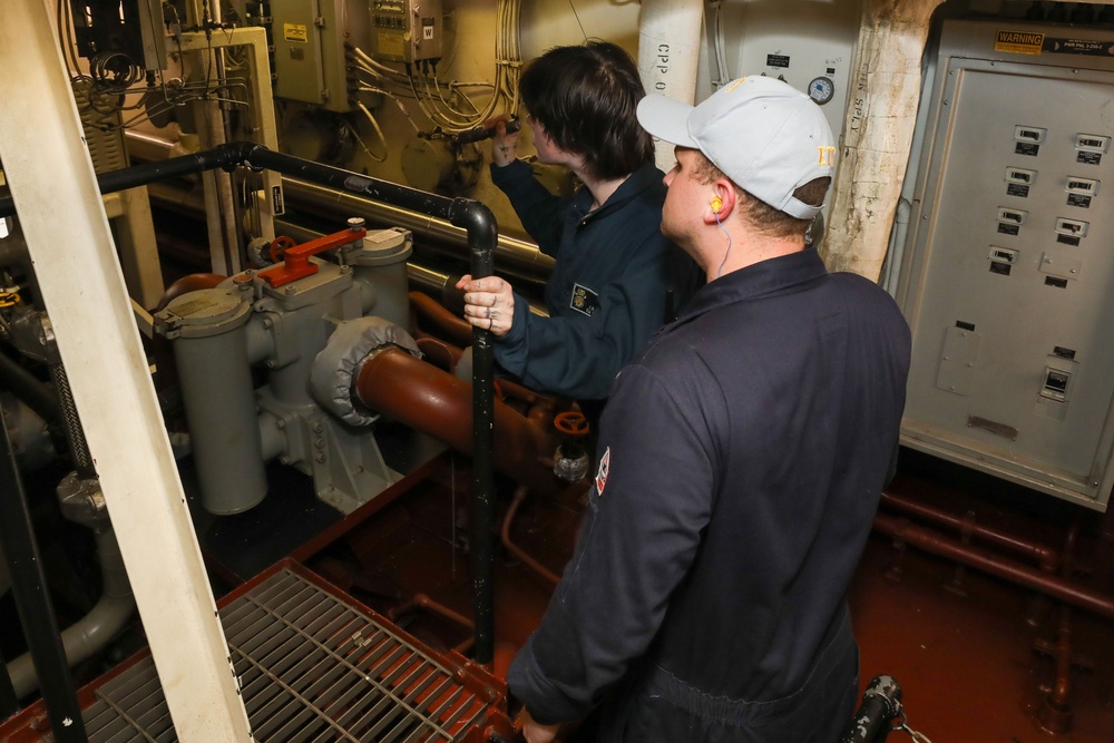 Sailors aboard the USS John Finn conduct an engineering training team drill in the South China Sea