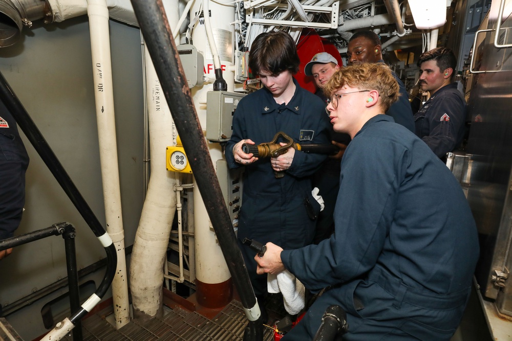 Sailors aboard the USS John Finn conduct an engineering training team drill in the South China Sea