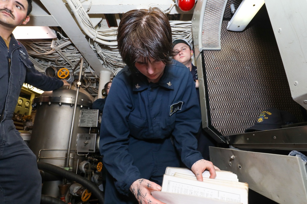 Sailors aboard the USS John Finn conduct an engineering training team drill in the South China Sea