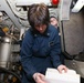 Sailors aboard the USS John Finn conduct an engineering training team drill in the South China Sea