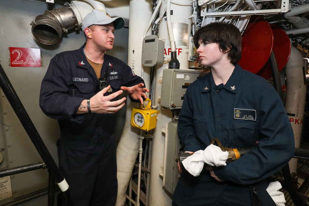 Sailors aboard the USS John Finn conduct an engineering training team drill in the South China Sea
