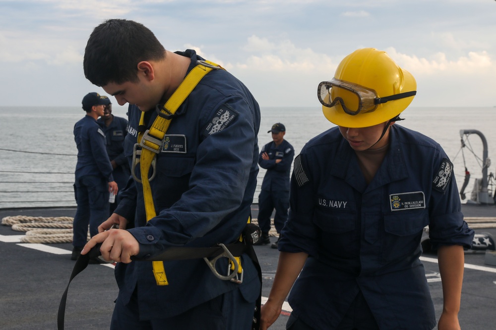 Sailors aboard the USS John Finn conduct a sea and anchor detail in Changi, Singapore