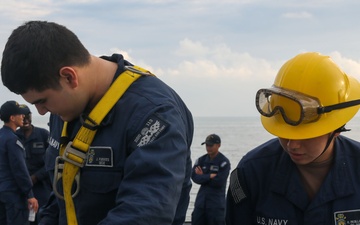 Sailors aboard the USS John Finn conduct a sea and anchor detail in Changi, Singapore