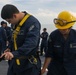 Sailors aboard the USS John Finn conduct a sea and anchor detail in Changi, Singapore