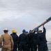 Sailors aboard the USS John Finn conduct a sea and anchor detail in Changi, Singapore