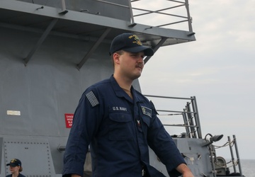 Sailors aboard the USS John Finn conduct a sea and anchor detail in Changi, Singapore