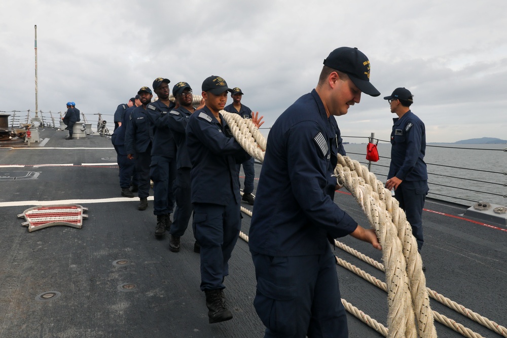 Sailors aboard the USS John Finn conduct a sea and anchor detail in Changi, Singapore