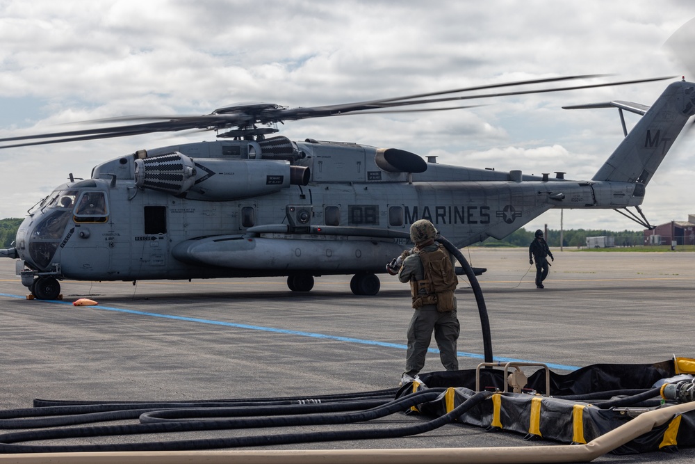 U.S. Marines with MWSS-273 refuel CH-53E Super Stallions with HMH-464