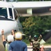 Sailors and contractors prep aircraft for launch