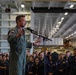 Abraham Lincoln conducts an all-hands call in the hangar bay