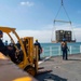 Sailors load medical supplies onto USNS Comfort