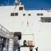 Sailors load medical supplies onto USNS Comfort
