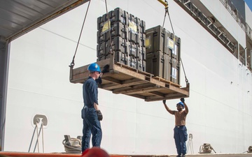 Sailors load medical supplies onto USNS Comfort