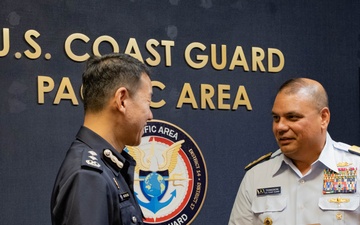 U.S. Coast Guard Pacific Area commander presents gift to Singapore Police Coast Guard leadership