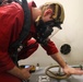 DC3 Levi Nuslein opens a water tight scuttle in response to a simulated toxic gas leak