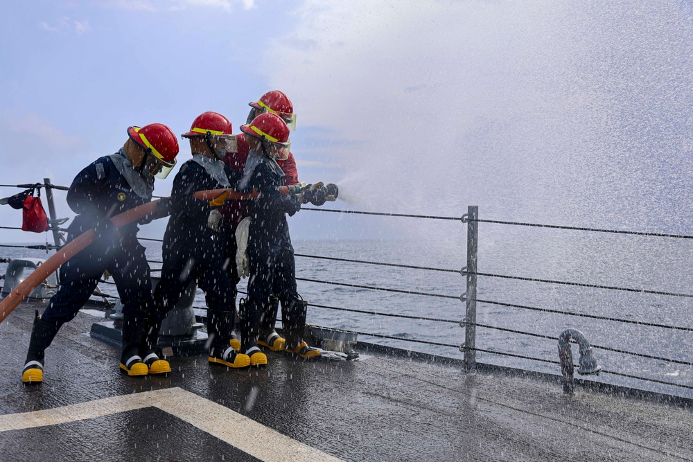 USS Bulkeley Sailors operate the firehose during a damage control evolution.