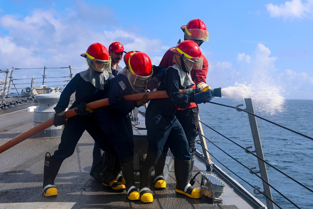 USS Bulkeley Sailors operate a firehose on the fo’c’sle during a damage control evolution