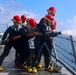 USS Bulkeley Sailors operate a firehose on the fo’c’sle during a damage control evolution