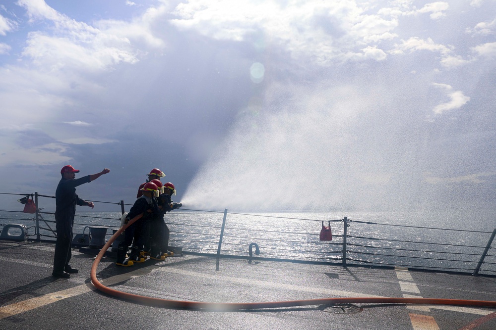 PSC William Brockman  instructs a fire team on the fo’c’sle during a damage control evolution