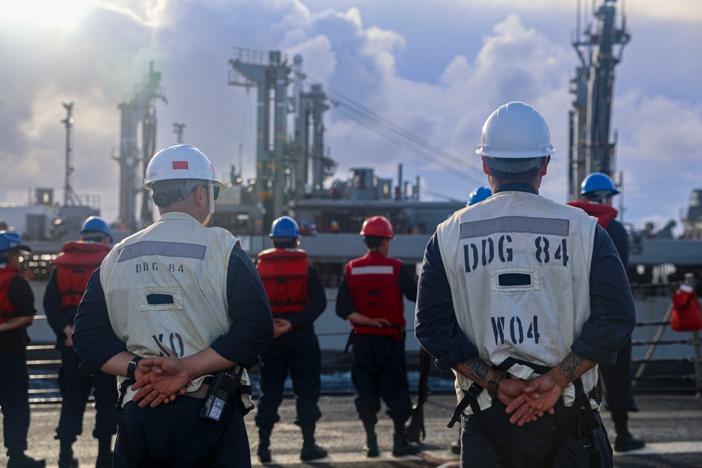 USS Bulkeley Sailors stand at parade rest on the foc’sle