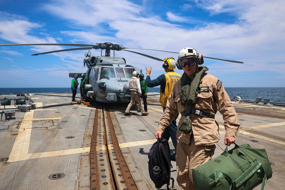 Lt. j.g. Jasper Lugo crosses the flight deck of the Arleigh Burke-class guided-missile destroyer USS Bulkeley