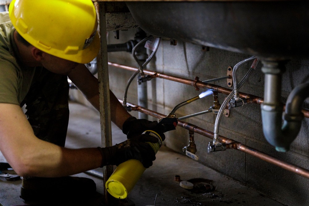Plumbers with the South Dakota Army National Guard conduct bathroom restoration project