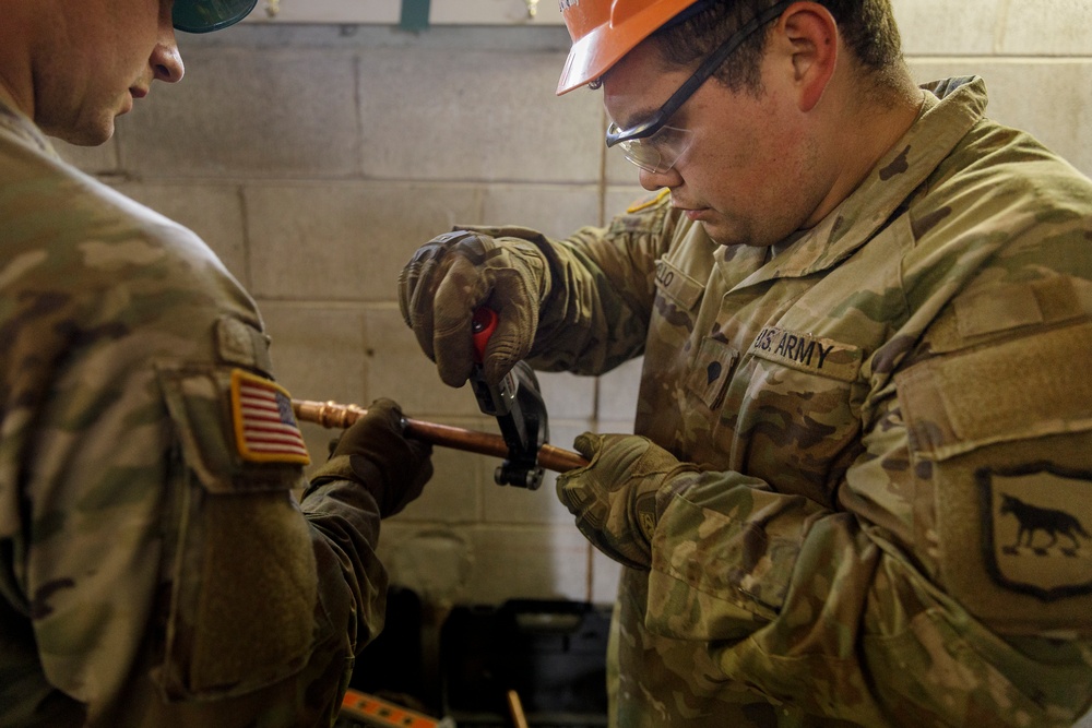 Plumbers with the South Dakota Army National Guard conduct bathroom restoration project