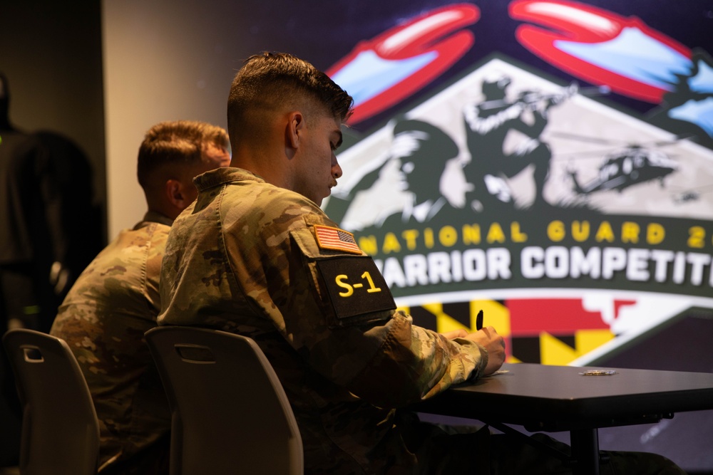 Army National Guard 2025 Best Warrior competitor takes notes during brief
