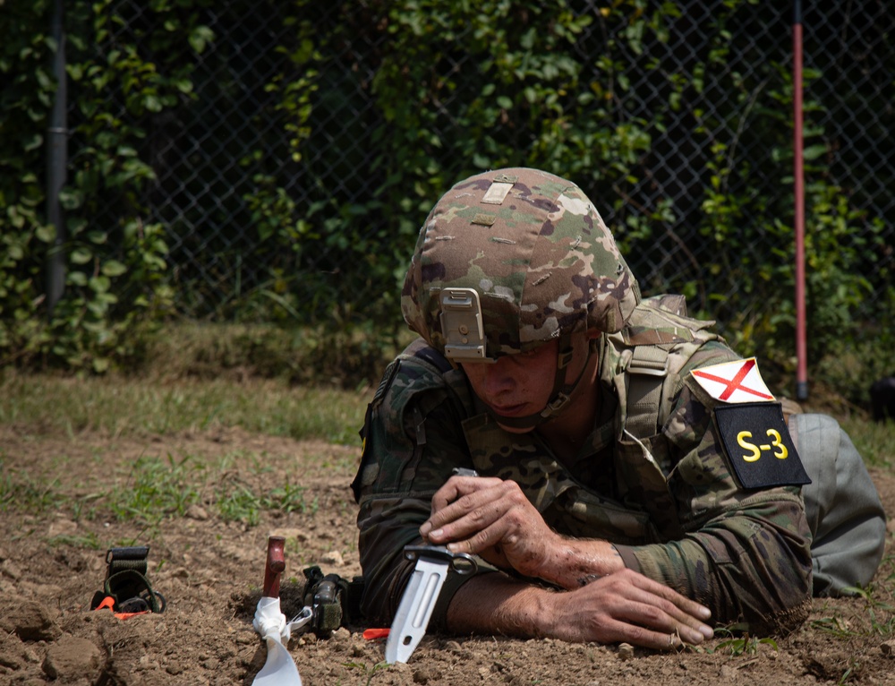 Spc. Jaden Hughes probes for buried landmines during Best Warrior 2025