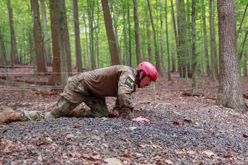 Sgt. Matthew Lee crawls in a obstacle course - 2025 National Best Warrior