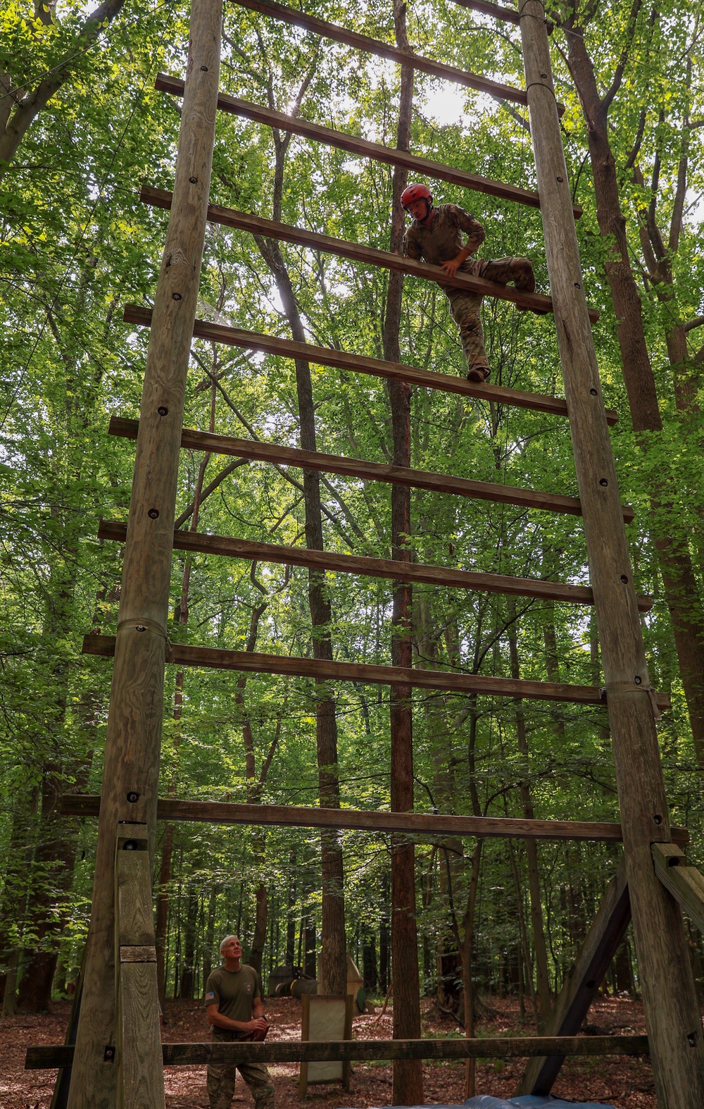 Spc. Adam Andrews climbs a ladder in an obstacle course - 2025 National Best Warrior