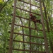 Spc. Adam Andrews climbs a ladder in an obstacle course - 2025 National Best Warrior