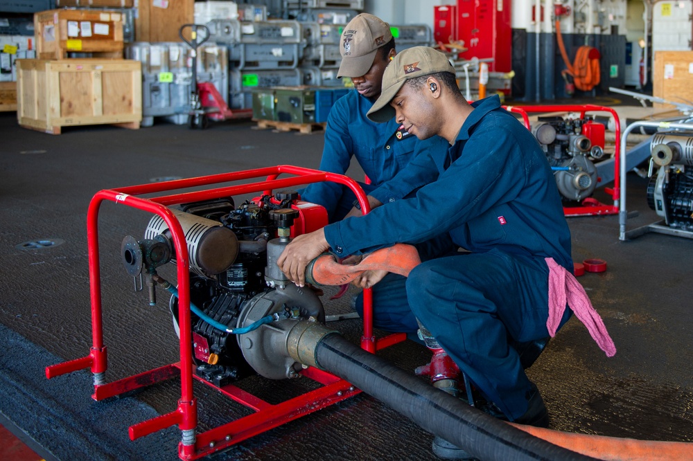 USS Essex Damage Controlman conduct P100 pump maintenance.