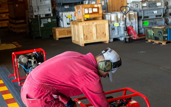 USS Essex Damage Controlman conduct P100 pump maintenance.
