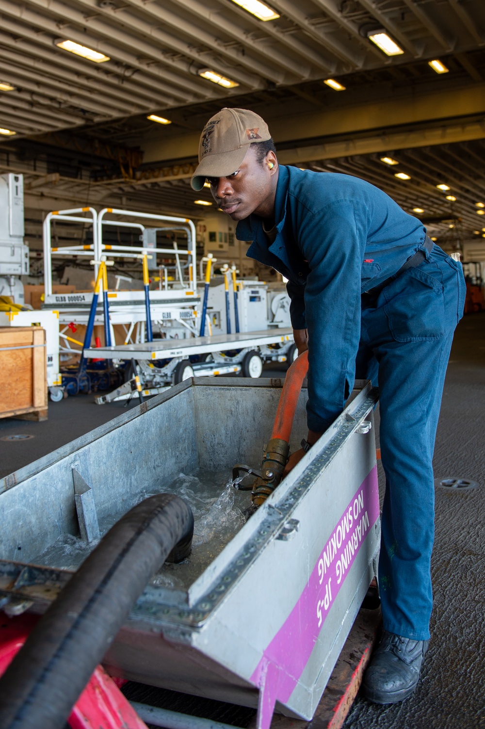 USS Essex Damage Controlman conduct P100 pump maintenance.