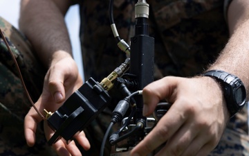 5th Air Naval Gunfire Liaison Company Marines craft expedient antennas with household goods