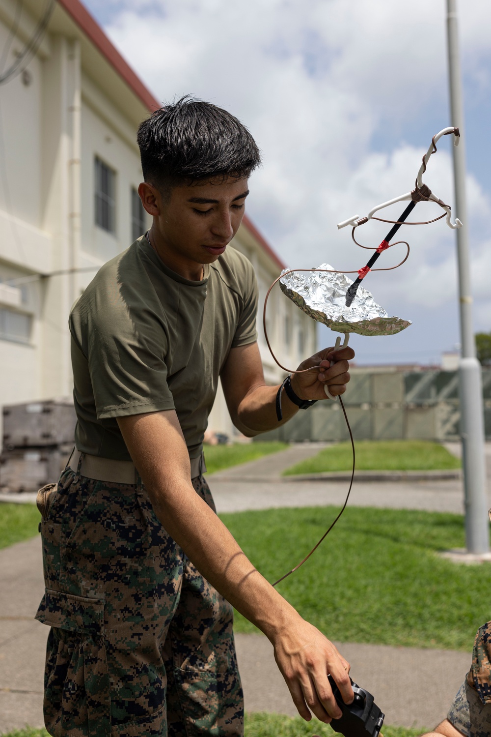 5th Air Naval Gunfire Liaison Company Marines craft expedient antennas with household goods
