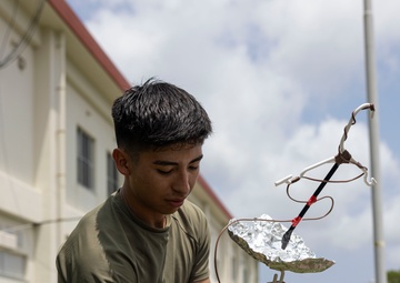 5th Air Naval Gunfire Liaison Company Marines craft expedient antennas with household goods