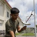 5th Air Naval Gunfire Liaison Company Marines craft expedient antennas with household goods