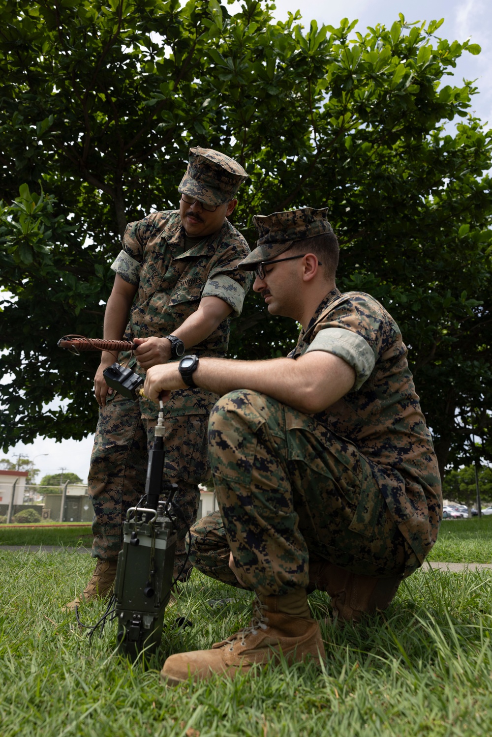 5th Air Naval Gunfire Liaison Company Marines craft expedient antennas with household goods