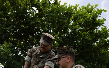 5th Air Naval Gunfire Liaison Company Marines craft expedient antennas with household goods