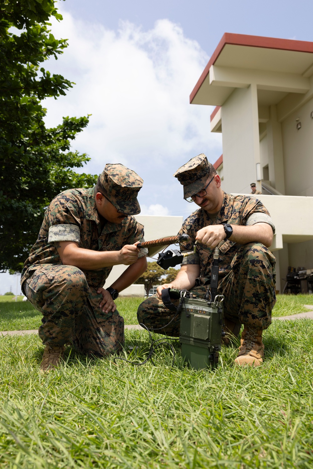 5th Air Naval Gunfire Liaison Company Marines craft expedient antennas with household goods