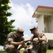 5th Air Naval Gunfire Liaison Company Marines craft expedient antennas with household goods