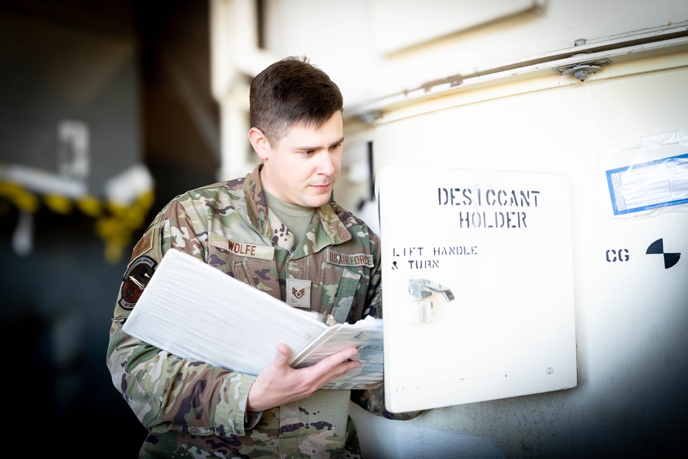 Staff Sgt. Nicholas Wolfe Inspects a desiccant holder at Edwards Air Force Base