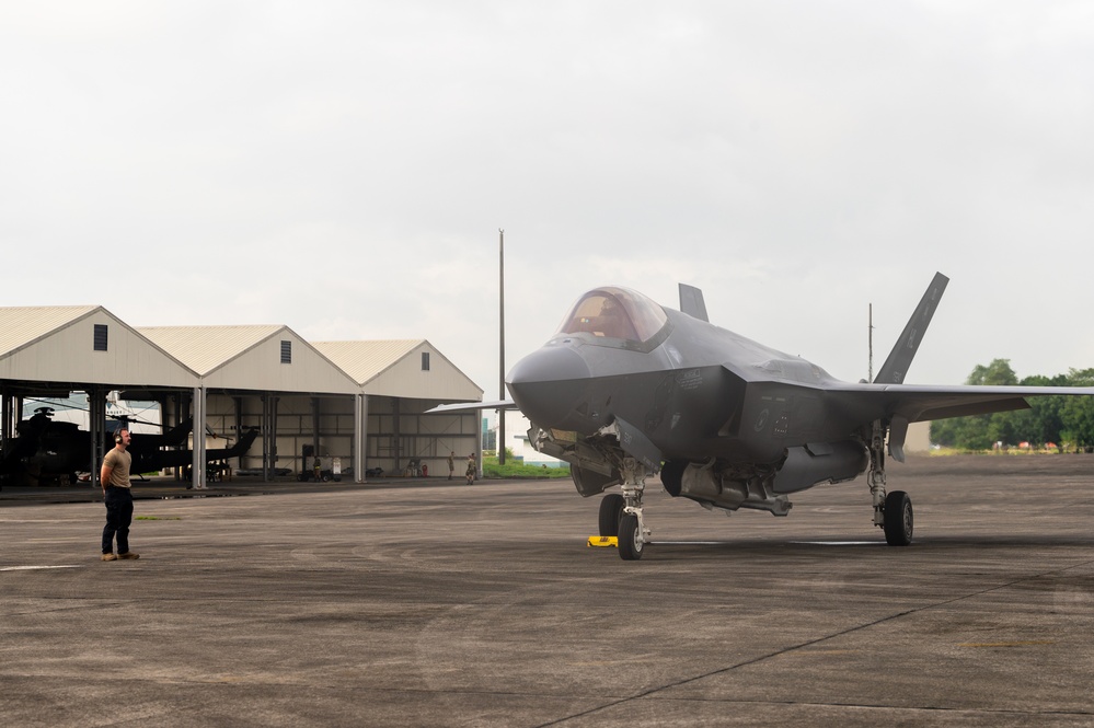 Cope Thunder 25-2: USAF crew chief marshals an F-35A Lightning II for departure