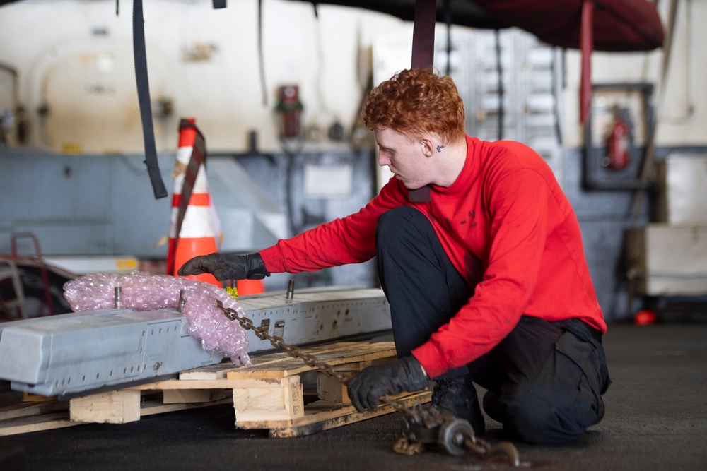 Nimitz Sailor Ties Down Equipment