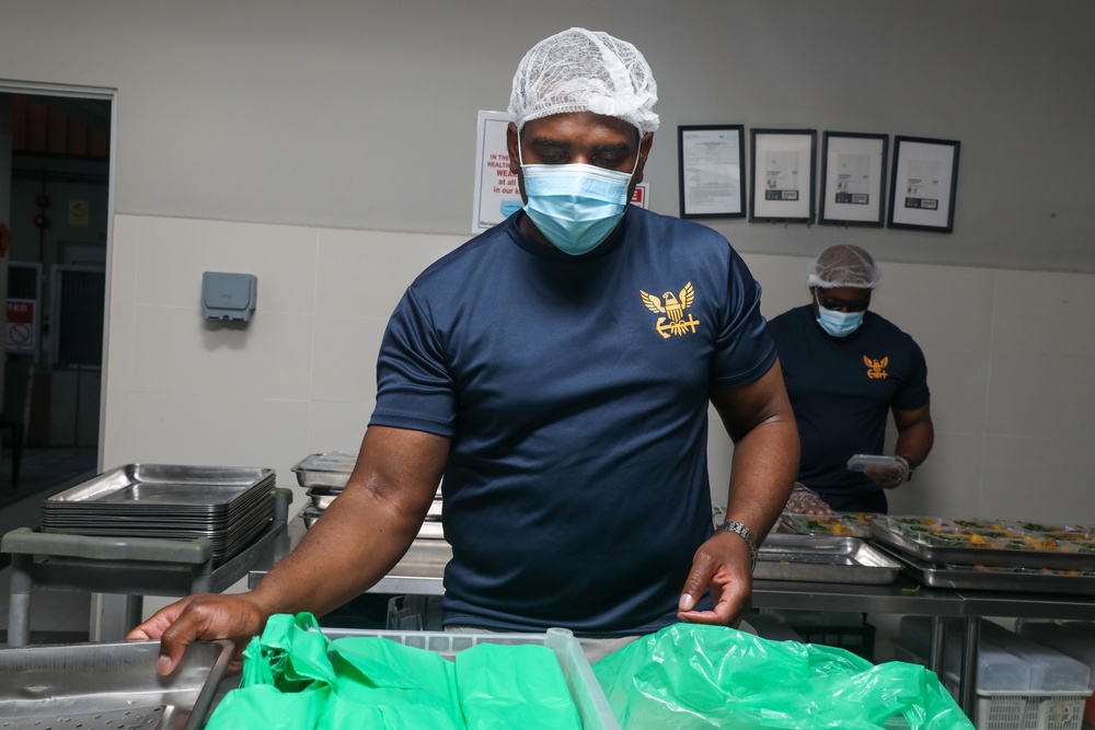 Sailors aboard the USS John Finn volunteer at Willing Hearts in Changi, Singapore