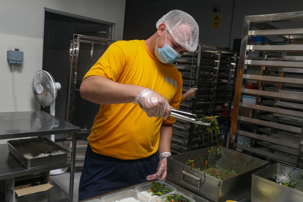 Sailors aboard the USS John Finn volunteer at Willing Hearts in Changi, Singapore