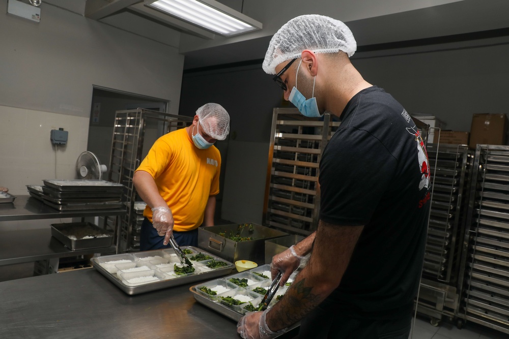 Sailors aboard the USS John Finn volunteer at Willing Hearts in Changi, Singapore