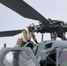 Sailors aboard the USS John Finn conduct routine maintenance on an MH-60R Sea Hawk in the Strait of Malacca